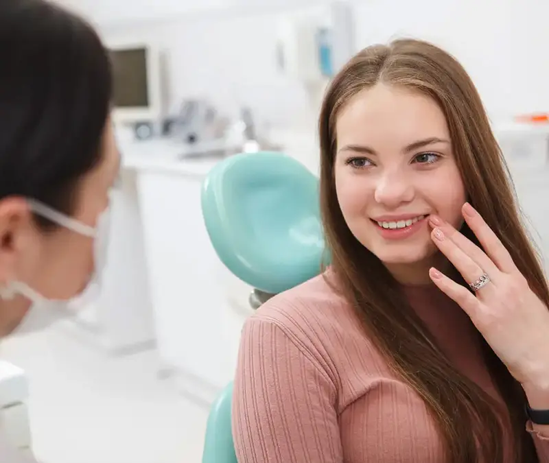 Dentist in Brantford at Conklin Family Dental discussing a patient's oral health questions during a check-up.